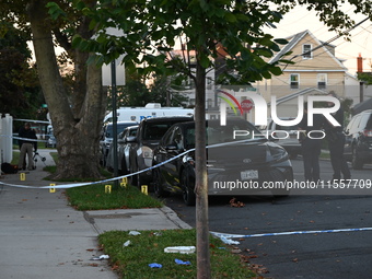 Crime scene investigators place evidence markers at the scene where three people are shot at 132-45 220th Street in Queens, New York, United...