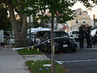 Crime scene investigators place evidence markers at the scene where three people are shot at 132-45 220th Street in Queens, New York, United...