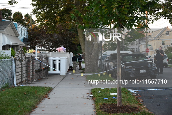 Crime scene investigators place evidence markers at the scene where three people are shot at 132-45 220th Street in Queens, New York, United...