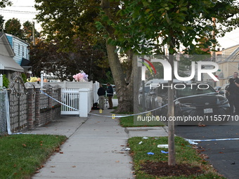 Crime scene investigators place evidence markers at the scene where three people are shot at 132-45 220th Street in Queens, New York, United...