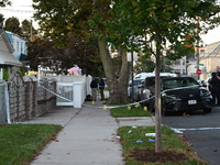 Crime scene investigators place evidence markers at the scene where three people are shot at 132-45 220th Street in Queens, New York, United...