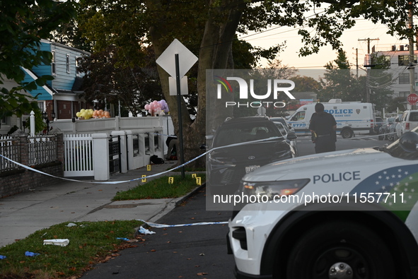 Crime scene investigators place evidence markers at the scene where three people are shot at 132-45 220th Street in Queens, New York, United...