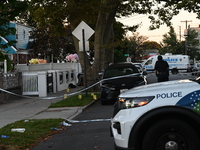 Crime scene investigators place evidence markers at the scene where three people are shot at 132-45 220th Street in Queens, New York, United...