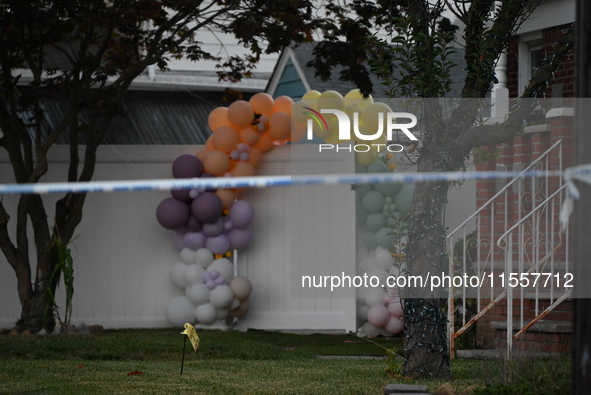 Crime scene investigators place evidence markers at the scene where three people are shot at 132-45 220th Street in Queens, New York, United...