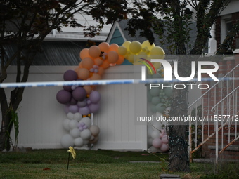 Crime scene investigators place evidence markers at the scene where three people are shot at 132-45 220th Street in Queens, New York, United...