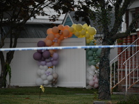 Crime scene investigators place evidence markers at the scene where three people are shot at 132-45 220th Street in Queens, New York, United...