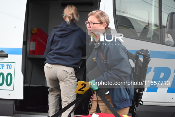 Crime scene investigators place evidence markers at the scene where three people are shot at 132-45 220th Street in Queens, New York, United...