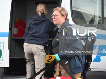 Crime scene investigators place evidence markers at the scene where three people are shot at 132-45 220th Street in Queens, New York, United...