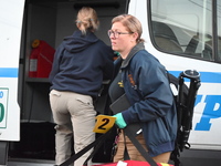 Crime scene investigators place evidence markers at the scene where three people are shot at 132-45 220th Street in Queens, New York, United...