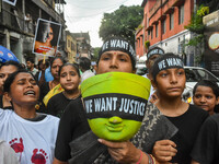 Artisans of Durga Puja and common citizens participate in a protest rally in Kolkata, India, on September 8, 2024, demanding justice for the...