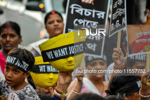 Artisans of Durga Puja and common citizens participate in a protest rally in Kolkata, India, on September 8, 2024, demanding justice for the...