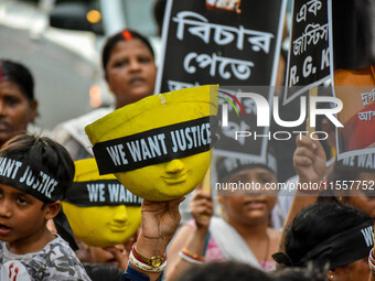 Artisans of Durga Puja and common citizens participate in a protest rally in Kolkata, India, on September 8, 2024, demanding justice for the...