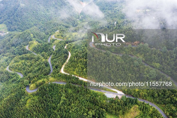 An aerial photo shows a winding rural road in Dingdong township, Congjiang county, in Guizhou province, China, on September 8, 2024. 