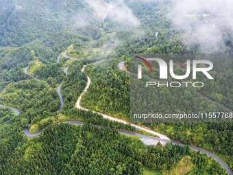 An aerial photo shows a winding rural road in Dingdong township, Congjiang county, in Guizhou province, China, on September 8, 2024. (