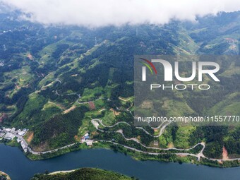 An aerial photo shows a winding rural road in Dingdong township, Congjiang county, in Guizhou province, China, on September 8, 2024. (