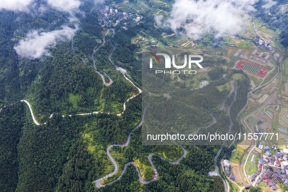 An aerial photo shows a winding rural road in Dingdong township, Congjiang county, in Guizhou province, China, on September 8, 2024. 