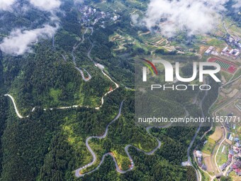 An aerial photo shows a winding rural road in Dingdong township, Congjiang county, in Guizhou province, China, on September 8, 2024. (