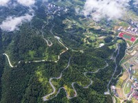 An aerial photo shows a winding rural road in Dingdong township, Congjiang county, in Guizhou province, China, on September 8, 2024. (