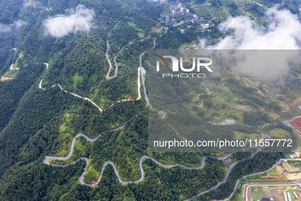 An aerial photo shows a winding rural road in Dingdong township, Congjiang county, in Guizhou province, China, on September 8, 2024. 