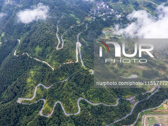 An aerial photo shows a winding rural road in Dingdong township, Congjiang county, in Guizhou province, China, on September 8, 2024. (