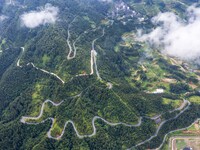 An aerial photo shows a winding rural road in Dingdong township, Congjiang county, in Guizhou province, China, on September 8, 2024. (