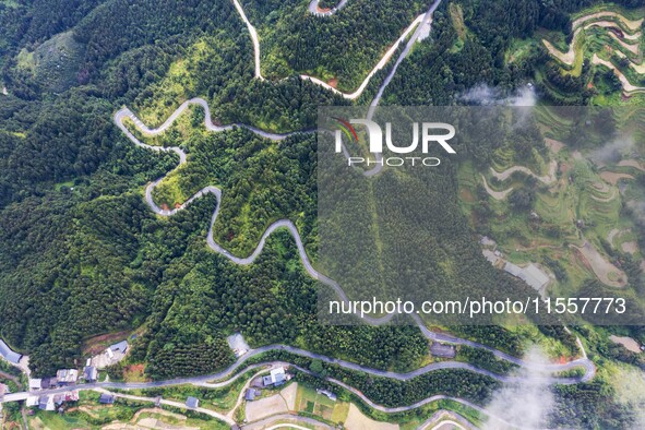 An aerial photo shows a winding rural road in Dingdong township, Congjiang county, in Guizhou province, China, on September 8, 2024. 