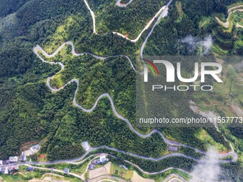 An aerial photo shows a winding rural road in Dingdong township, Congjiang county, in Guizhou province, China, on September 8, 2024. (