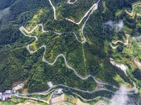 An aerial photo shows a winding rural road in Dingdong township, Congjiang county, in Guizhou province, China, on September 8, 2024. (