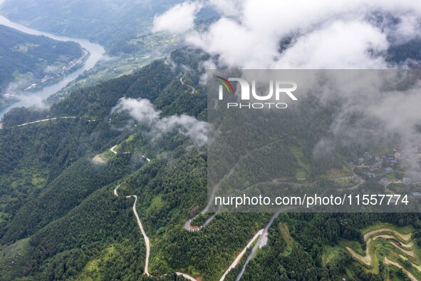 An aerial photo shows a winding rural road in Dingdong township, Congjiang county, in Guizhou province, China, on September 8, 2024. 