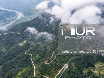 An aerial photo shows a winding rural road in Dingdong township, Congjiang county, in Guizhou province, China, on September 8, 2024. (