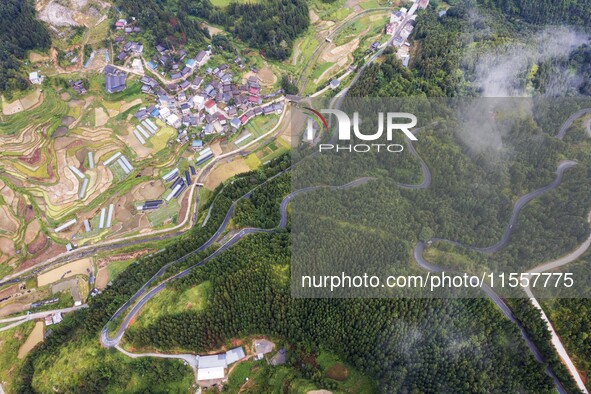 An aerial photo shows a winding rural road in Dingdong township, Congjiang county, in Guizhou province, China, on September 8, 2024. 