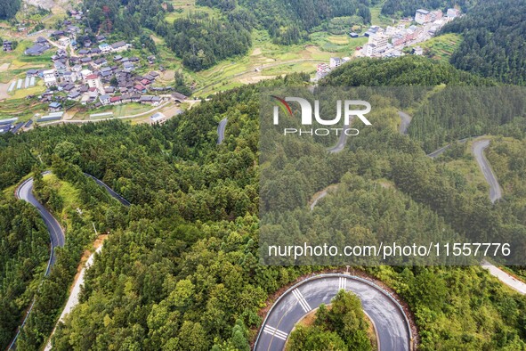 An aerial photo shows a winding rural road in Dingdong township, Congjiang county, in Guizhou province, China, on September 8, 2024. 