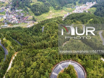 An aerial photo shows a winding rural road in Dingdong township, Congjiang county, in Guizhou province, China, on September 8, 2024. (