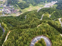 An aerial photo shows a winding rural road in Dingdong township, Congjiang county, in Guizhou province, China, on September 8, 2024. (