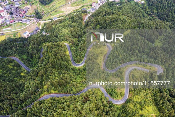 An aerial photo shows a winding rural road in Dingdong township, Congjiang county, in Guizhou province, China, on September 8, 2024. 