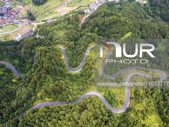 An aerial photo shows a winding rural road in Dingdong township, Congjiang county, in Guizhou province, China, on September 8, 2024. (