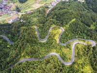 An aerial photo shows a winding rural road in Dingdong township, Congjiang county, in Guizhou province, China, on September 8, 2024. (