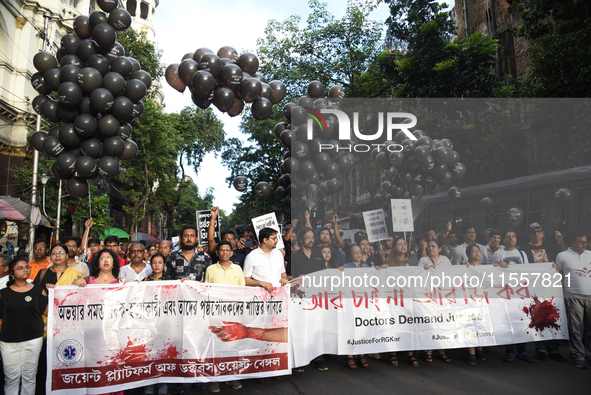 Members of the West Bengal Junior and Senior Doctors' Front march along a street during a protest condemning the rape and murder of a traine...