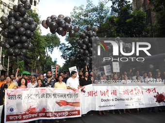 Members of the West Bengal Junior and Senior Doctors' Front march along a street during a protest condemning the rape and murder of a traine...