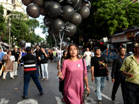 People march along a street during a protest condemning the rape and murder of a trainee medic at a government-run hospital in Kolkata, Indi...