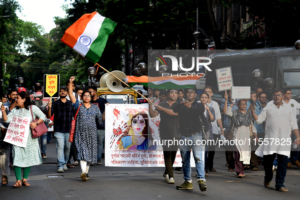 Members of the West Bengal Junior and Senior Doctors' Front march along a street during a protest condemning the rape and murder of a traine...