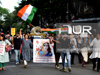 Members of the West Bengal Junior and Senior Doctors' Front march along a street during a protest condemning the rape and murder of a traine...