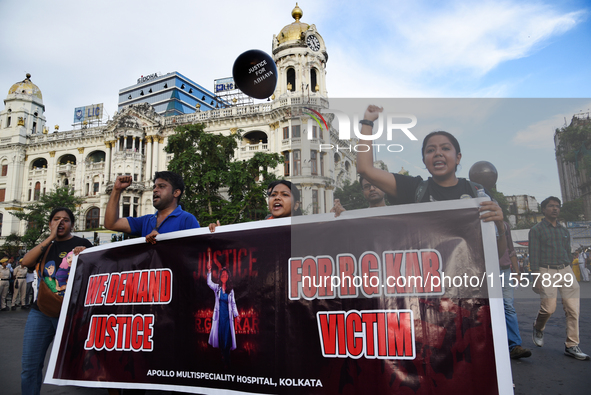 Members of the West Bengal Junior and Senior Doctors' Front march along a street during a protest condemning the rape and murder of a traine...