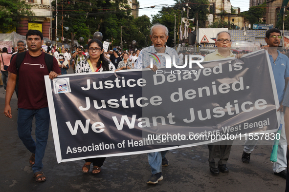 Members of the West Bengal Junior and Senior Doctors' Front march along a street during a protest condemning the rape and murder of a traine...