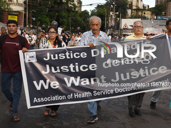 Members of the West Bengal Junior and Senior Doctors' Front march along a street during a protest condemning the rape and murder of a traine...