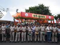 Police stand in front of the BJP agitation stage during a protest condemning the rape and murder of a trainee medic at a government-run hosp...