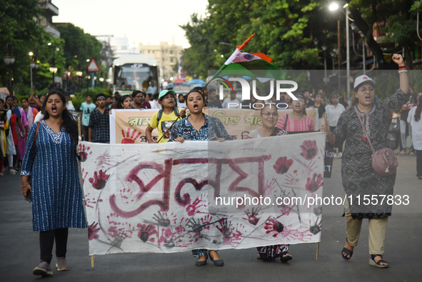 Citizens march along a street during a protest condemning the rape and murder of a trainee medic at a government-run hospital in Kolkata, In...