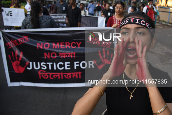 Citizens march along a street during a protest condemning the rape and murder of a trainee medic at a government-run hospital in Kolkata, In...