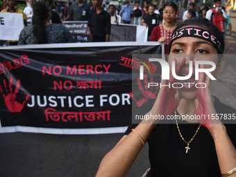 Citizens march along a street during a protest condemning the rape and murder of a trainee medic at a government-run hospital in Kolkata, In...