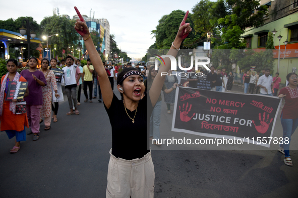 Citizens march along a street during a protest condemning the rape and murder of a trainee medic at a government-run hospital in Kolkata, In...